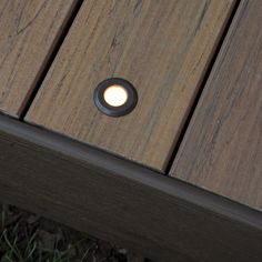 a close up of a light on the side of a wooden bench