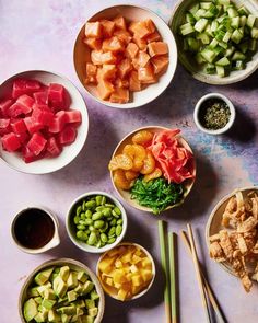 bowls filled with different types of food on top of a table next to chopsticks