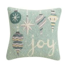 a decorative pillow with christmas ornaments on it