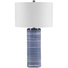 a blue and white lamp with a white shade on the top, sitting in front of a white background