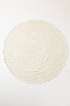 a white circular rug on top of a table