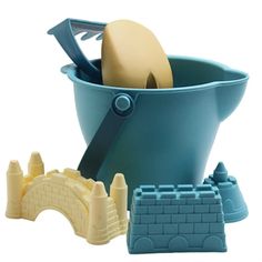 there is a sand castle and shovel in the bucket