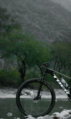 a bike parked on the side of a river