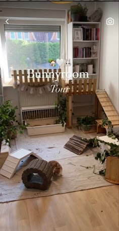 a living room filled with furniture next to a window and bookshelf in the corner