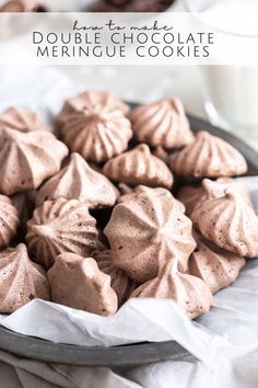 chocolate meringue cookies on a plate with milk in the background and text overlay