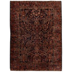 an antique persian rug with red and black colors