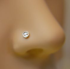 a close up view of a nose with a small button on it