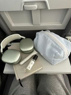 an airplane seat with headphones and other items on it