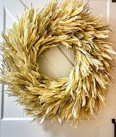 a dried wreath hanging on the front door