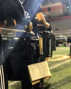 the band is playing on the field at night