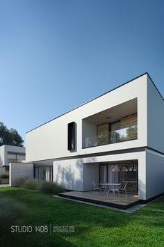 a white house sitting on top of a lush green field