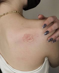 a woman with a rose tattoo on her back