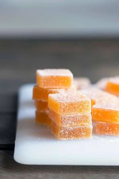 small pieces of sugary orange candy on a white plate