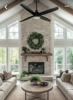 a living room filled with furniture and a fire place in front of a stone fireplace