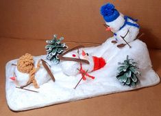 a snowman is on top of a pile of fake pine cones and other decorations