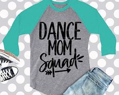 a shirt that says dance mom squad next to shorts and converse shoes on a polka dot background