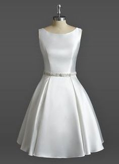 a white dress on a mannequin dummy with a belt around the waist and neckline