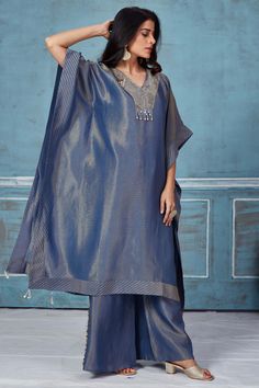 Turn heads at weddings and special occasions in this stylish blue embroidered tissue georgette kaftan and pant set. DISCLAIMER: The actual product may vary slightly from the image. These are custom orders, hence expect slight variation in color and placement of the motif or buta. ESTIMATED DELIVERY: Because this is a custom order, it would take about 4 weeks from the date of purchase. RETURN POLICY: This product is a custom order and cannot be returned or exchanged. Blue Palazzo Set With Chikankari Embroidery For Reception, Blue Chikankari Embroidery Palazzo Set For Reception, Blue Traditional Drape Georgette Palazzo Set, Blue Silk Palazzo Set With Sheer Dupatta, Blue Kurta With Sheer Dupatta For Reception, Blue Palazzo Set With Sheer Dupatta For Reception, Blue Straight Kurta Set For Reception, Festive Blue Kaftan With Dupatta, Elegant Blue Kaftan With Dupatta