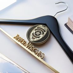 a pair of black and gold scissors next to a hanger with the words winter virgins on it