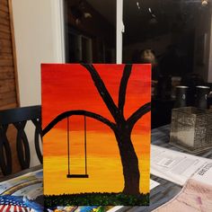 an acrylic painting of a tree with a swing in the sky at sunset