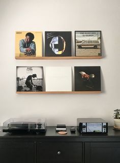 the wall is filled with various records and pictures on it's sides, along with an old record player