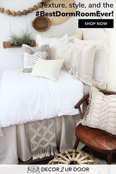 a bed with white sheets and pillows on it in front of a wall mounted plant