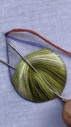 the needle is being used to thread yarn