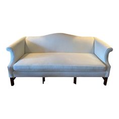 a white couch sitting on top of a wooden frame