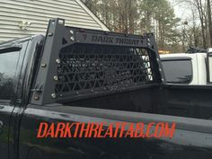 the back end of a black truck with an extra heavy cage on it's bed