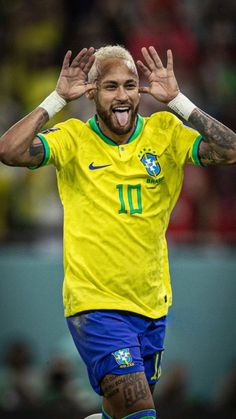 a soccer player with his hands in the air