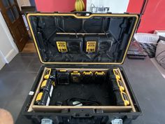 an open tool box with tools inside on the floor