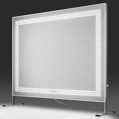 a large mirror with lights on it in front of a black background and white floor