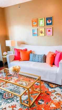 a living room filled with lots of furniture and colorful pillows on top of it's couch