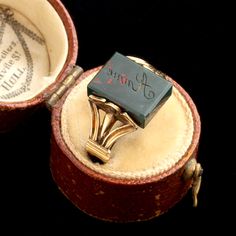 a ring that is in a box with some writing on it