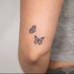 two butterflies tattoo on the arm