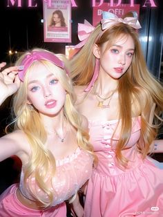 two young women dressed in pink posing for the camera