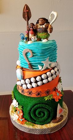 a multi layer cake with many different decorations on it