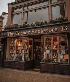 the corner bookstore 13 is located in an old brick building with flower boxes on it's windows