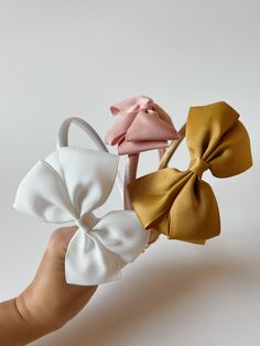 These headband bows are timeless and comfortable for babies and toddlers. They come in three colors. Adjustable Summer Headband With Satin Bow, Spring Satin Bow Headband, Adjustable Bow With Matching Headband For Spring, White Bow Tie Hair Accessories For Summer, Adjustable White Satin Bow, Playful Adjustable Bow Headband, Adjustable White Bow With Matching Headband, White Bow With Matching Headband, White Headband With Bow Tie