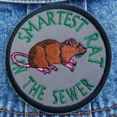 a patch that says smart rat in the sewer on it's back pocket