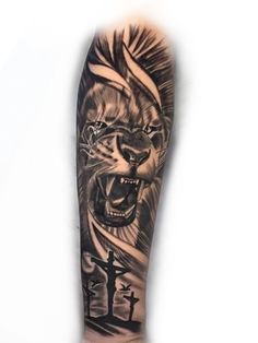 a man's arm with a tiger and cross tattoo on it