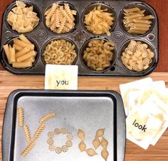 there are many different types of pasta in the trays on the table, including noodles