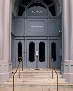 an entrance to a large building with columns