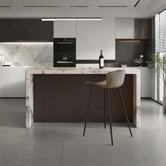 a modern kitchen with marble counter tops and bar stools