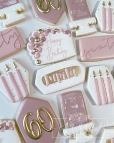 pink and gold birthday cookies are arranged on a white tablecloth with the number 60