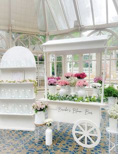 a white cart filled with lots of flowers