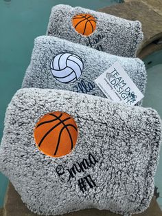 three towels with basketballs on them sitting next to a pool