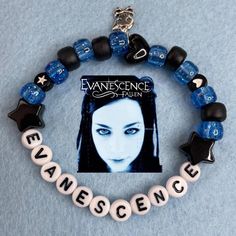 a blue bracelet with black beads and white letters that read evanesence on it