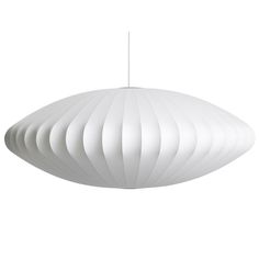 a white light hanging from the ceiling on a string in front of a white background