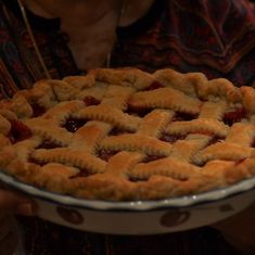 a person holding a pie in their hands